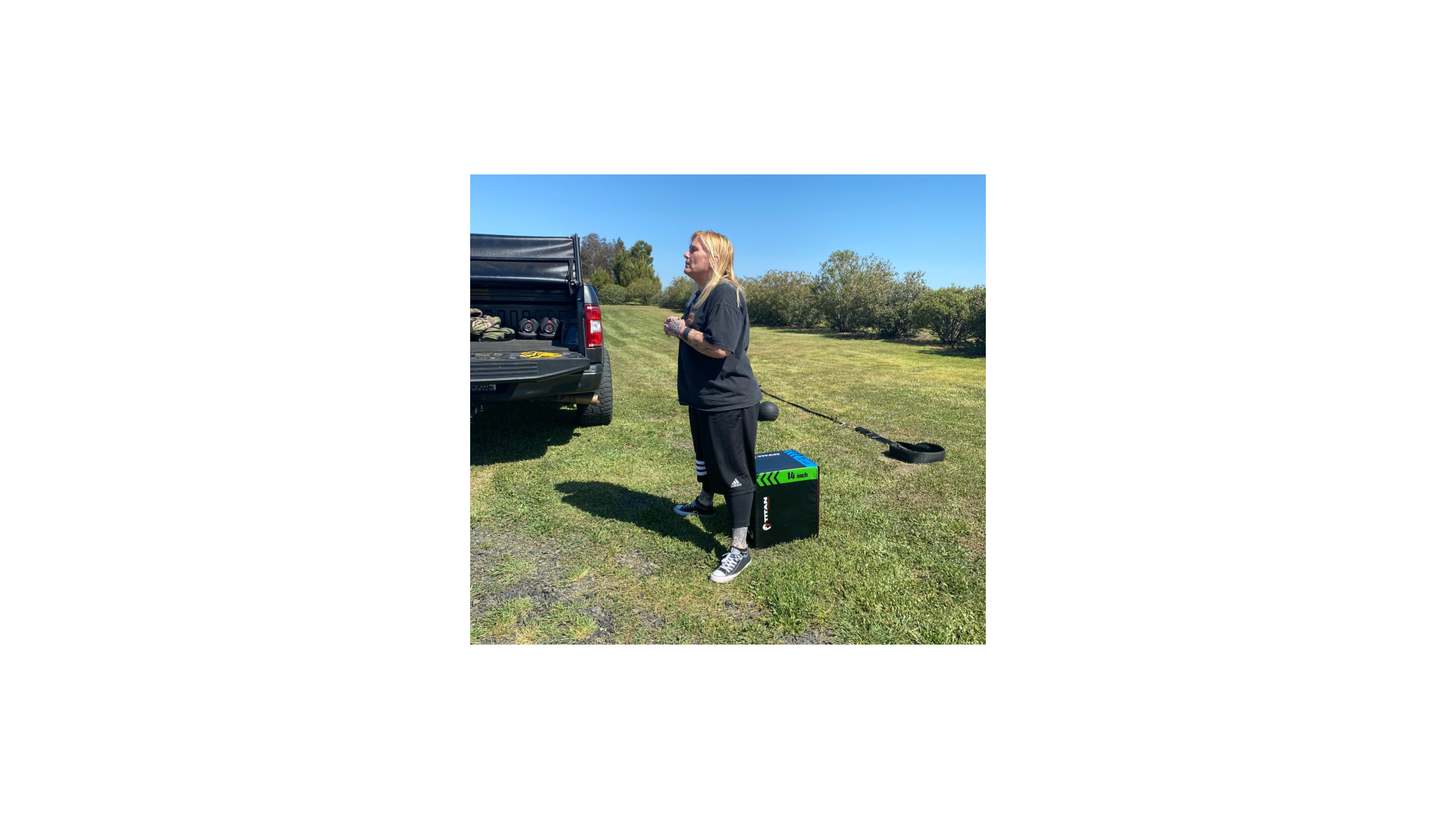 Woman doing senior fitness training outdoor workout in Chico, CA with Gym Truck Chico — active older adult exercising near the mobile gym truck in a sunny park setting